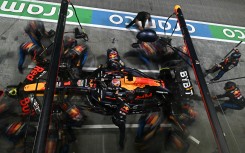 Team mechanics work on the car of Red Bull Racing's Dutch driver Max Verstappen in the pits. AFP/Lilian Suwanrumpha