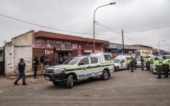 SAPS cars are seen during an inspections on spaza shops in Naledi, Soweto. AFP/Shiraaz Mohamed