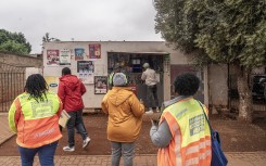 Officials about to conduct an inspection on a spaza shop in Naledi, Soweto. AFP/Shiraaz Mohamed