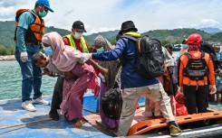 Search and rescue members evacuate Rohingya refugees from a boat. AFP/Chaideer Mahyuddin