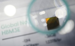 A display for South Korean chip giant SK Hynix's 16-layer HBM3E chip. AFP/Anthony Wallace