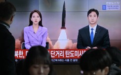 A man watches a television showing a news broadcast with file footage of a North Korean missile test. AFP/Anthony Wallace