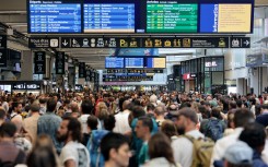 Passengers gather around the departure and arrival boards at the Gare Montparnasse train station in Paris. AFP/Thibaud Moritz