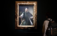 A visitor looks at the private collection by Italian master Caravaggio. AFP/Alberto Pizzoli