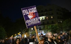 Protestors hold a banner reading 'Enough, lower the rents' during a demonstration. AFP/Josep Lago