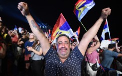 A supporter of Uruguay's president-elect, Yamandu Orsi, of the Frente Amplio coalition, celebrates after the presidential runoff election in Montevideo. AFP/Dante Fernandez