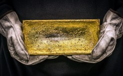 File: A miner holding a 20kg gold brick. AFP/David Gray