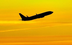 Aircraft silhouette, a symbol illustration photo during the magic hour of a departing passenger plane. 