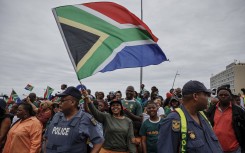 File: A fan waves a South African flag during the Springboks Champions trophy tour in East London. AFP/Wikus de Wet