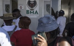 Zimbabwean migrants wishing to enter South Africa queue at a passport check before the immigration offices at the Beitbridge crossing. AFP/Marco Longari