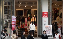 Customers pass by Uniqlo's global flagship store in Shanghai, China. CFOTO/NurPhoto via AFP