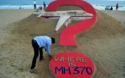 File:  Indian sand artist Sudarsan Pattnaik creating a sand sculpture of the missing Malaysia Airlines flight MH370 on Puri beach. AFP/J .K. Jagdev