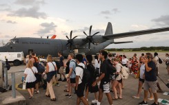 Australian Defence Force personnel assisting Australians off a C-130J Hercules at Brisbane Airport following an earthquake which struck Port Vila, Vanuatu. AFP/Adam Abela/DFAT