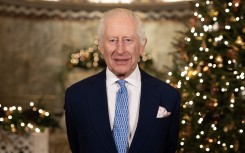 Britain's King Charles III smiles during the recording of his Christmas message. AFP/Aaron Chown