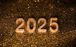 Happy New Year 2025 wooden numbers are photographed. Beata Zawrzel/NurPhoto via AFP