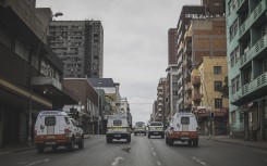File: SAPS and JMPD vehicles drive in Hillbrow. AFP/Marco Longari