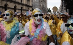 Members of minstrels groups sing and dance as they march during the annual Tweede Nuwe Jaar parade. AFP/Rodger Bosch