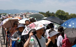 Tourists visit the Summer Palace amid hot weather. Jia Tianyong/cnsphoto/Imaginechina via AFP