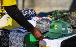 A supporter of the ANC examines party merchandise. AFP/Rodger Bosch