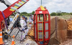 Operators look on as a cage is lifted from an abandoned gold shaft in Stilfontein. AFP/Linda Givetash