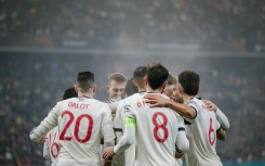 Manchester United's English midfielder #37 Kobbie Mainoo (hidden) celebrates with team mates after scoring the 0-2 goal. AFP/Andrei Pungovschi