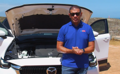 image of Justin Ford standing against white Mazda on Drive episode 07