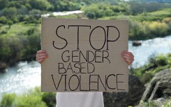 File: A sign calling for gender-based violence to be stopped. GettyImages/Liudmila Chernetska