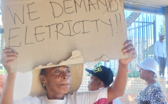 One of the protesters with a sign. eNCA/Hloni Mtimkulu