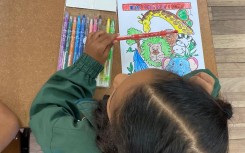 Back to school: A grade one pupil sits on her desk as schools reopen