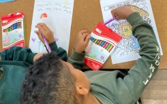 Back to school: A grade one pupil sits on his desk as schools reopen