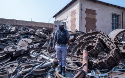 File: A private security guard looks on in a scrapyard during a raid. AFP/Emmanuel Croset