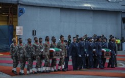 Military pallbearers accompany the caskets of the SANDF soldiers killed in the DRC. AFP/Phill Magakoe