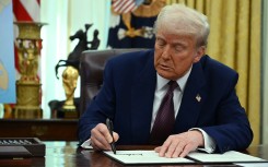 US President Donald Trump signs an Executive Order on reciprocal tariffs in the Oval Office of the White House. AFP/Andrew Caballero-Reynolds