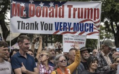 South Africans supporting US President Donald Trump and South African and US tech billionaire Elon Musk gather in front of the US Embassy in Pretoria. AFP/Marco Longari