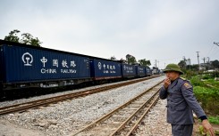 A railway worker guiding a train in Hanoi. AFP/Nhac Nguyen