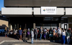 People queue outside the SASSA office to exchange SASSA cards for the new Postbank Black Cards. Gallo Images/Die Burger/Jaco Marais