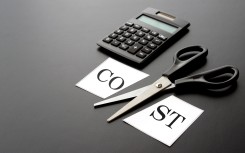File: Cost-cutting with a calculator. GettyImages/takasuu