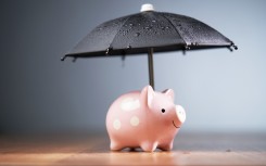 File: A piggy bank with an umbrella. GettyImages/seng kui Lim/500px