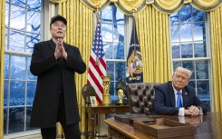 Elon Musk speaks as US President Donald Trump looks on in the Oval Office. AFP/Jim Watson.jpg
