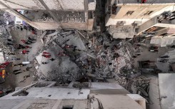 Syrian civil defence members and first responders inspecting the site of an explosion in Syria's western coastal city of Latakia. AFP/SANA