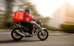 File: A delivery biker on a motorbike. GettyImages/Amanda Caroline da Silva