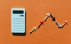 A calculator and a graph with arrows representing inflation. GettyImages/Maryna Terletska