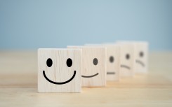 Wooden blocks representing happiness and sadness. GettyImages/Wipada Wipawin