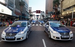 File: Members of the Metro Police drive their cars through to the central streets of Durban. AFP/Rajesh Jantilal