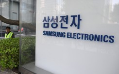 A man walks past the logo of Samsung Electronics displayed outside the company's Seocho building in Seoul. AFP/Jung Yeon-je
