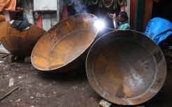 A worker is welding the joints of a giant utensil at an iron utensils manufacturing unit in Kolkata. Rupak De Chowdhuri/NurPhoto via AFP