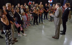 Afrikaners listen to US Deputy Secretary of State Christopher Landau and Homeland Security Deputy Secretary Troy Edgar after arriving in the US. Chip Somodevilla/Getty Images/AFP