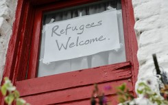 Sign on a window saying "Refugees Welcome". GettyImages/Stephen Barnes