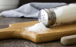 Salt spilling out of a salt shaker. GettyImages/Synergee