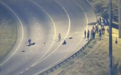 Protesters placing objects on the road.